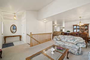 Living area featuring a chandelier and light colored carpet