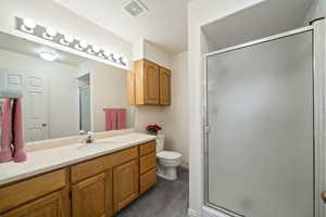 Bathroom featuring vanity and a shower stall