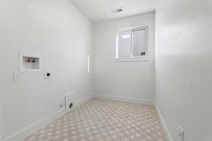 Washroom with washer hookup, electric dryer hookup, and tile patterned floors