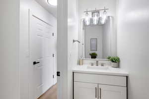 Bathroom featuring vanity and light wood-style flooring
