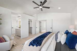 Master Bedroom featuring vaulted ceiling, a walk in closet, ensuite bath, a ceiling fan, and carpet