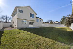 Back of house with a patio area, a fenced backyard, and a gate