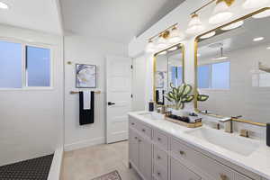 Master Bathroom with double vanity, a walk in shower, and recessed lighting