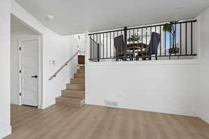 Stairway featuring wood finished floors and baseboards