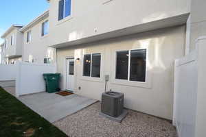 Rear view of property featuring a patio and stucco siding