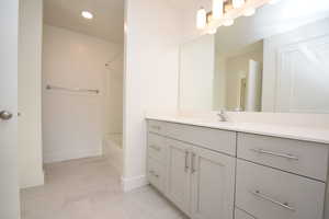 Bathroom featuring vanity, bathing tub / shower combination, and recessed lighting