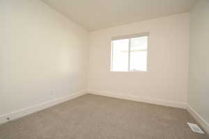 Carpeted empty room with baseboards