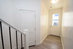 Hall featuring light wood-style flooring and stairway