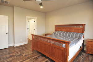 Bedroom with dark wood finished floors and a ceiling fan
