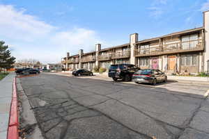 View of asphalt road with curbs and sidewalks