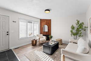 Living area featuring a textured ceiling and light wood-type flooring