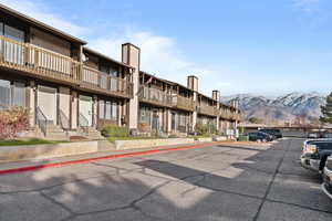 View of property featuring uncovered parking and a mountain view