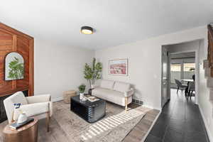 Living area featuring baseboards and wood finished floors