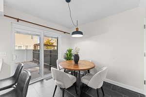 Dining area with tile patterned floors and baseboards