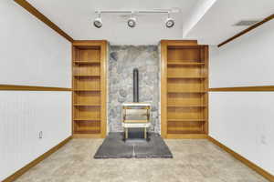 Living room with a wood stove and rail lighting