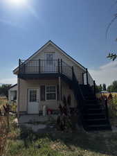 Rear view of property with a patio, stairway, and a wooden deck