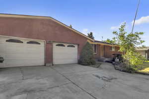 View of front of property featuring concrete driveway and brick siding