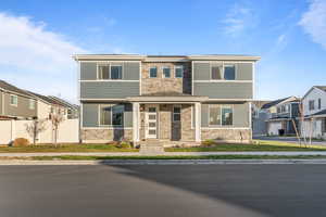View of front of house featuring stone siding, a porch, and a residential view