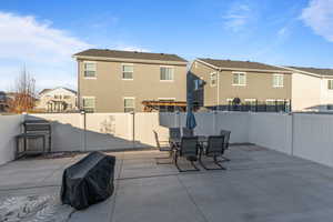 Fenced backyard featuring a residential view, a patio area, area for grilling, and outdoor dining space