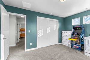 Home office with light colored carpet and baseboards