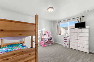 Carpeted bedroom featuring baseboards