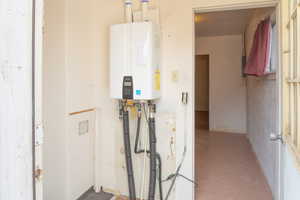 Utility room featuring newer tankless water heater