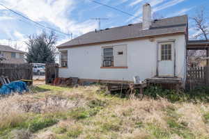 Rear view of the home featuring newer roof with shingles