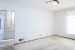 Family room with ceiling fan and large windows