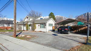View of front of home featuring a carport and asphalt driveway