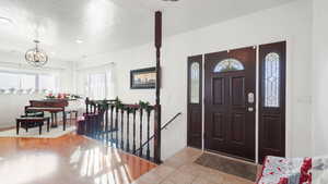 Foyer featuring healthy amount of natural light, recessed lighting, and light tile patterned floors