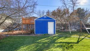 View of shed with a fenced backyard