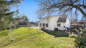 Back of house with roof with shingles and a patio area