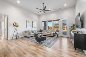 Living room featuring light wood-type flooring, recessed lighting, and ceiling fan