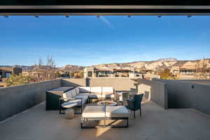 View of patio with a residential view, a mountain view, and an outdoor living space with a fire pit