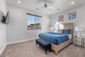 Bedroom featuring light carpet, ceiling fan, and recessed lighting