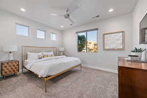 Bedroom with a ceiling fan, light colored carpet, and recessed lighting