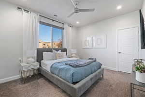 Bedroom with carpet flooring, ceiling fan, and recessed lighting
