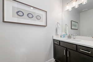 Bathroom featuring vanity and baseboards