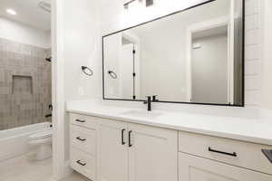 Full bath with vanity, shower / bath combination, and light tile patterned floors
