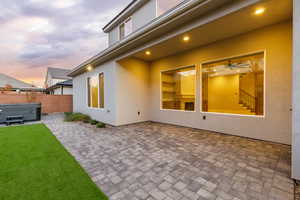 Fenced backyard featuring a patio area and a hot tub