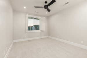 Spare room featuring light carpet, ceiling fan, and recessed lighting