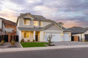 Craftsman inspired home with board and batten siding, a porch, decorative driveway, a garage, and brick siding