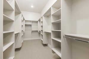 Spacious closet with light carpet