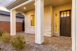 Property entrance with brick siding and stucco siding
