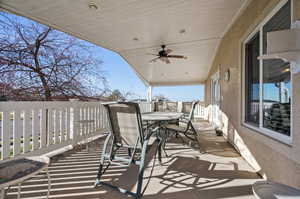 Balcony featuring outdoor dining space and a ceiling fan