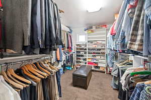 Walk in closet featuring light carpet