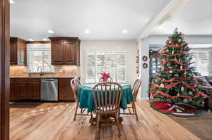 Dining space featuring crown molding, light wood finished floors, and recessed lighting