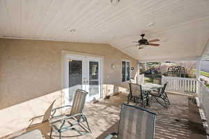 Deck with outdoor dining area, ceiling fan, and french doors