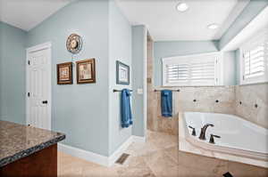 Full bathroom featuring a bath, vanity, recessed lighting, and a walk in shower