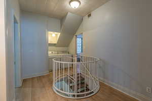 Additional living space featuring light wood-type flooring and washing machine and clothes dryer